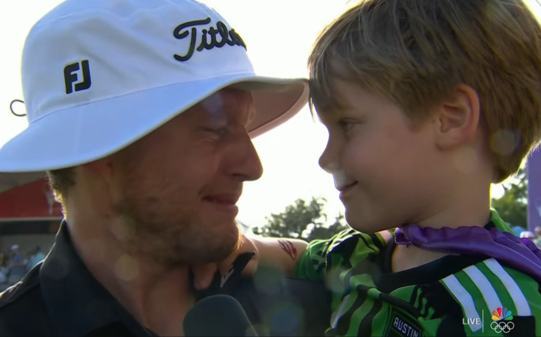 Golfer Peter Malnati celebrates winning the Valspar tournament, with his young son